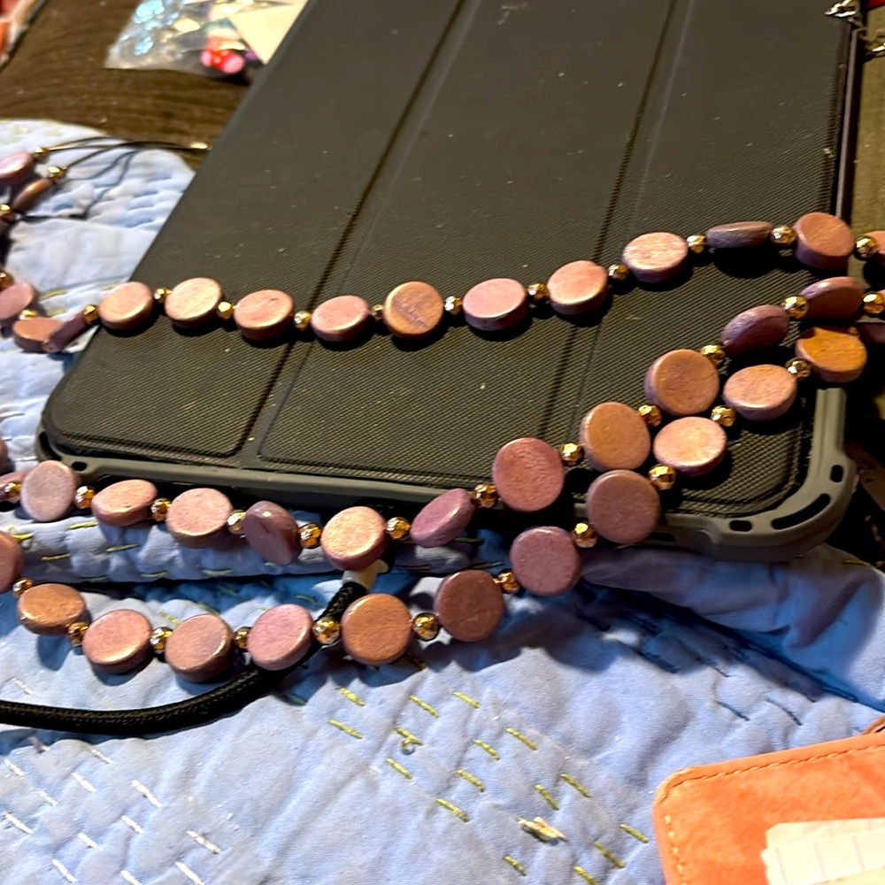 Vintage 3 strand round flat beads, interspersed with smaller, round metal beads.